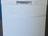 an image of a white dishwasher in a garage