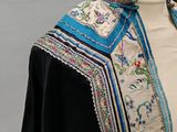 a mannequin with a blue and white scarf on a mannequin