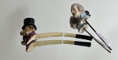 a figurine of a man with a top hat and cane next to a pair of scissors