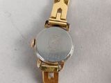 a close up of a watch on a white surface with a white background