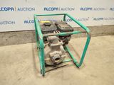a small engine sitting on top of a green cart