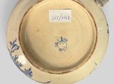 a blue and white plate with a bird on it