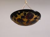 a bowl hanging from a rope on the ceiling