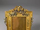 an image of a gold frame with flowers and leaves on it
