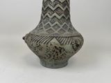 a vase that is sitting on a white surface