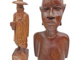 two wooden sculptures of a man and a woman with a hat