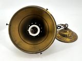 a brass lamp that is sitting on a white surface