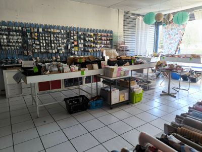 a large room with a lot of craft supplies on the tables