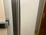 a white refrigerator in the corner of a room