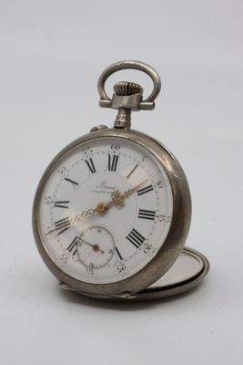 a silver pocket watch with roman numerals on it
