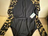 a close up of a swim suit on a hanger on a wall