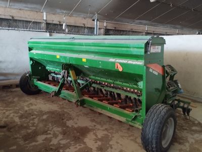 a large green machine that is parked in a building