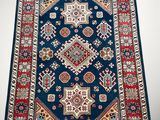 a blue rug with a red border and a white background