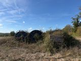 a field with a bunch of blue barrels in it