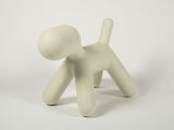 a small white figurine of a dog on a white background