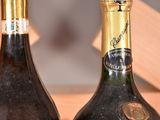 two bottles of wine sitting next to each other on a table
