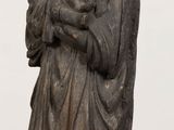 statue of a woman holding a child in her arms on a table