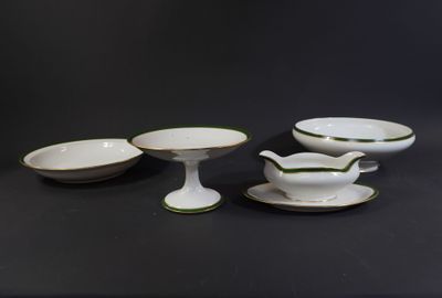 four pieces of white and green china on a black table