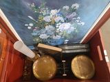 a painting on the wall behind a wooden box