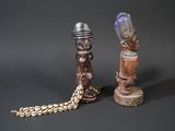 two wooden figurines sitting next to each other on a table