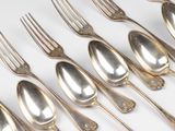 a lot of silver spoons and forks on a white table