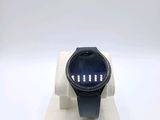 a watch that is sitting on a stand on a white surface