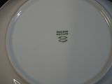 a white plate with a green design on it