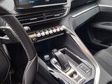 a picture of a car dashboard with a monitor and steering wheel