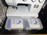 three plastic containers with sewing machines on a table