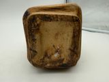 an image of a small wooden block on a white surface