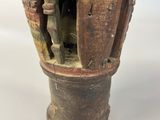 a vase that is sitting on a white surface