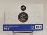 a close up of a coin on a stand with a sticker