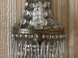 wall sconce with crystal drops hanging from it on a wall