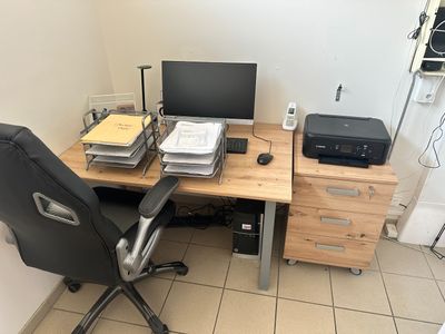 un bureau sur lequel se trouvent un ordinateur et une imprimante