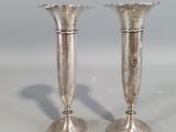 two silver candlesticks sitting on a table