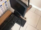 a computer and keyboard on the floor next to a cardboard box