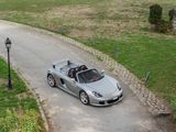 a silver sports car driving down the road