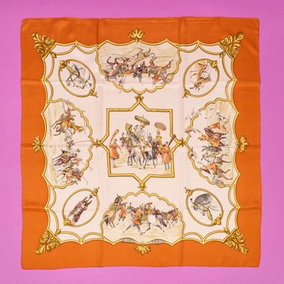 an orange and white square scarf with a picture of men on horseback