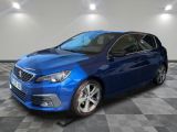 a blue car is parked in a room with a checkered floor