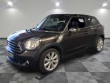 the mini countryman is parked on a checkered tile floor