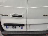 the rear end of a white van parked on the side of the road