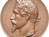 an image of a bronze coin with a man ' s face on it