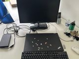 a desk with a computer, keyboard, mouse, and other items on it