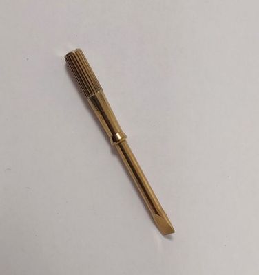 a close up of a pen laying on top of a white surface