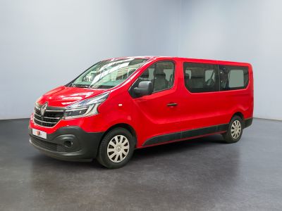the red van is parked in a room with a black floor