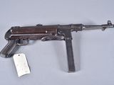an old gun with a tag attached to it sitting on a table