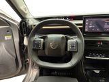 the interior of a car with a steering wheel and dashboard controls