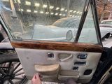 a man that is sitting inside of a car with the door open