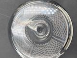 an overhead view of a clear glass object on a black surface