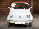 a small white car that is parked in a garage